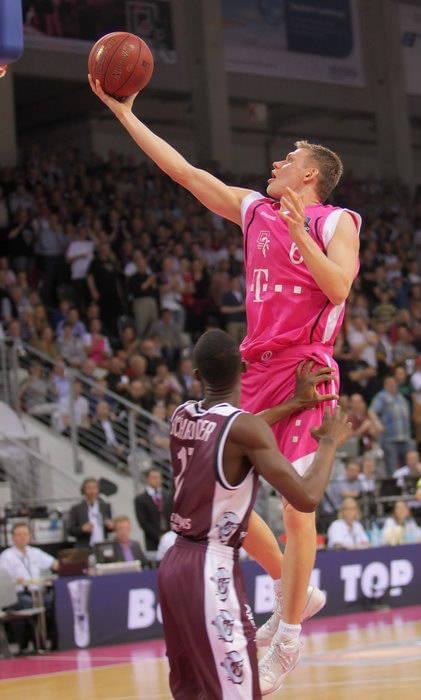 Benas Veikalas - professional basketball player Mortgage Broker Slam Dunk Mortgage Team Viera Melbourne Florida, mid-air in game.