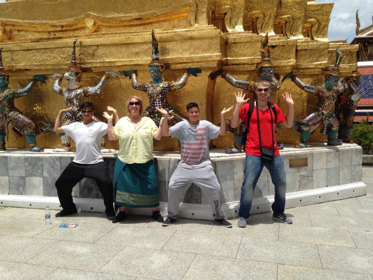 Stacey Sandlin Benas Veikalas Mortgage Broker Slam Dunk Mortgage Team Viera Melbourne Florida, family travels at Ornate Golden Temple”. The picture captures a group of people standing in front of an intricately designed golden temple, adorned with statues and ornate details.