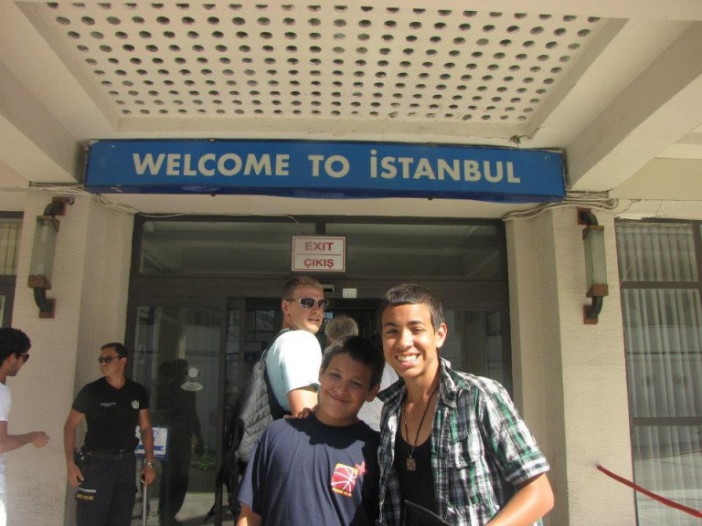 Stacey Sandlin Benas Veikalas Mortgage Broker Slam Dunk Mortgage Team Viera Melbourne Florida, family travels to Istanbul Welcome Sign with Slam Dunk Mortgage Team Family , entrance adorned with a blue sign that reads “WELCOME TO ISTANBUL” in white capital letters. Below the sign, there’s an exit door labeled “ÇIKIŞ.”