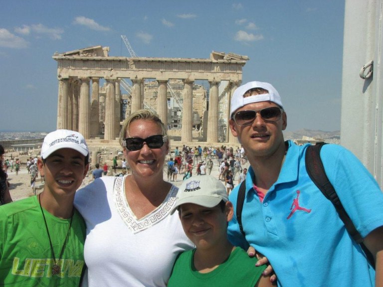 Stacey Sandlin Benas Veikalas Mortgage Broker Slam Dunk Mortgage Team Viera Melbourne Florida, family travels at the Parthenon in Athens”. The photo captures three individuals standing in front of the iconic Parthenon, an ancient temple atop the Acropolis in Athens.