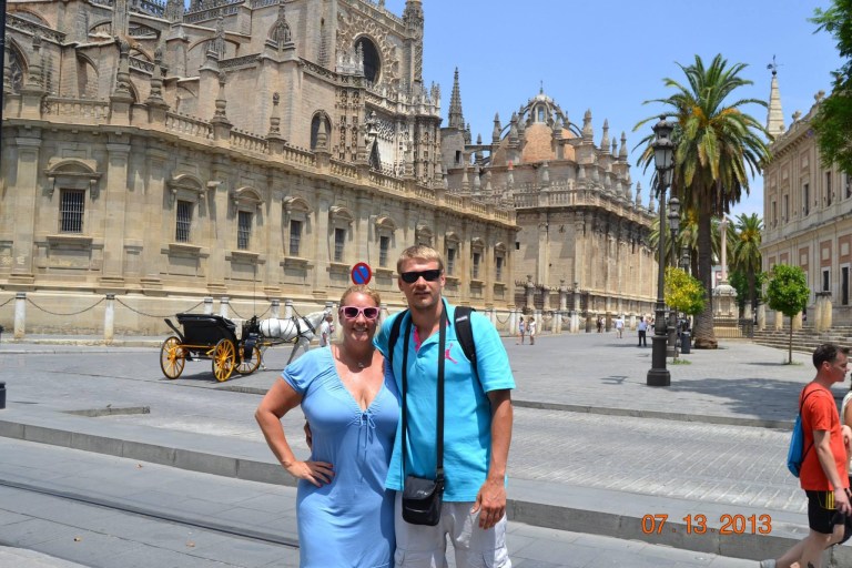 Stacey Sandlin Benas Veikalas Mortgage Broker Slam Dunk Mortgage Team Viera Melbourne Florida, family travels, standing in front of the ornate Seville Cathedral on a sunny day.