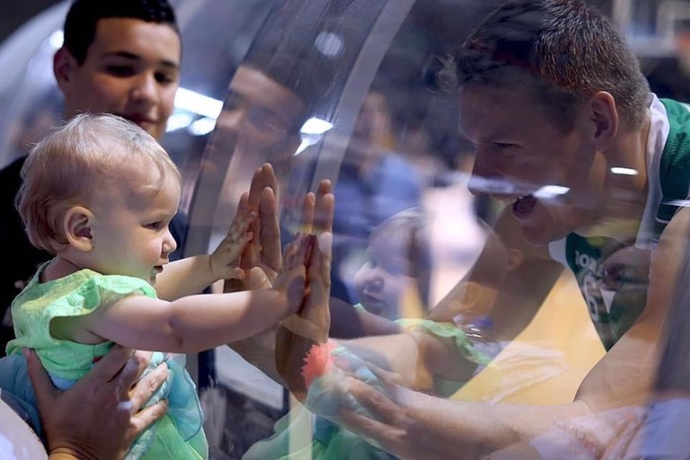 Slam Dunk Mortgage Team, Mortgage Broker Viera, Melbourne Florida, basketball game with Amber holding the glass looking at her father Benas Veikalas.